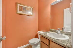 Half bathroom with vanity and light tile patterned floors