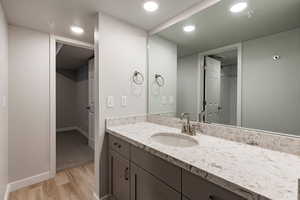Bathroom featuring vanity, light wood-type flooring, and recessed lighting