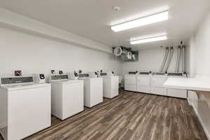 Shared laundry room featuring washer and clothes dryer and a textured ceiling