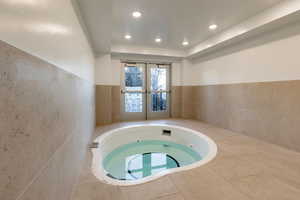 View of pool featuring a hot tub