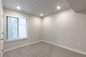 Unfurnished room featuring carpet floors and recessed lighting