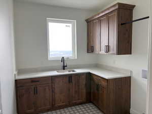 Kitchen with dark wood finish cabinetry and light floors