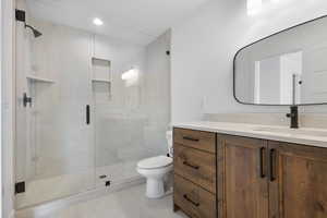 Full bathroom with vanity and a stall shower