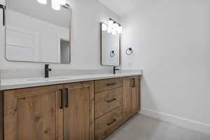 Bathroom featuring double vanity and light tile patterned floors