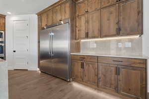 Kitchen featuring stainless steel appliances, light wood-style floors, wood finish cabinets, and recessed lighting