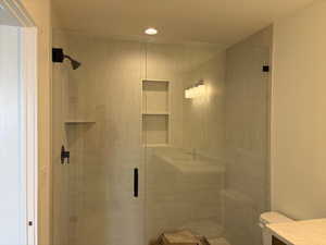 Bathroom with a stall shower and vanity