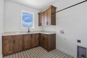 Laundry room featuring washer hookup, cabinet space, light floors, and hookup for an electric dryer