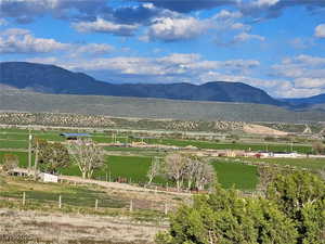 View of mountain backdrop featuring rural landscape