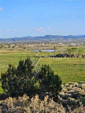 View of mountain background featuring rural landscape and a large body of water