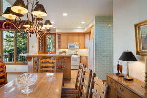 Dining area featuring a chandelier and light wood finished floors
