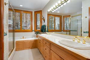 Full bathroom with a bath, a shower stall, wallpapered walls, double vanity, and recessed lighting