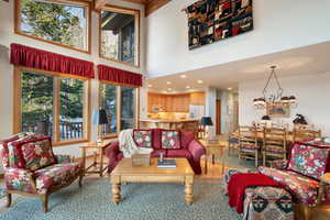 Living room featuring light wood finished floors and suspended lighting
