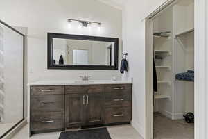 Bathroom with vanity, a stall shower, and light carpet