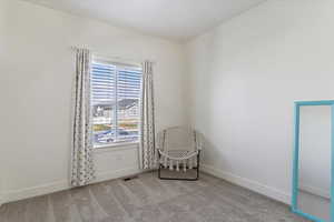 Sitting room featuring light carpet and baseboards