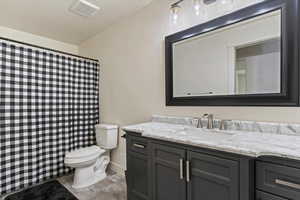 Full bath with vanity, a shower with curtain, and light wood finished floors