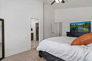 Bedroom featuring light carpet, a ceiling fan, and lofted ceiling