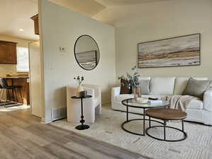 Living room featuring light wood-type flooring and baseboards