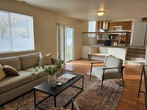 Living room with light wood-style flooring and a textured ceiling