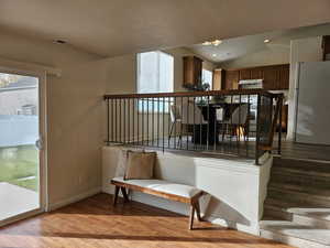 Stairway with wood finished floors, a textured ceiling, and recessed lighting