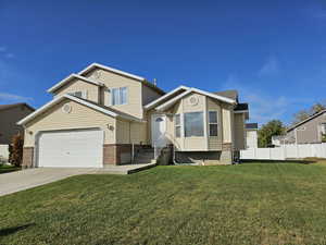 View of front of house featuring concrete driveway, brick siding, and an attached garage
