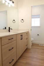 Bathroom featuring vanity and light wood-type flooring