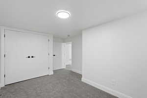 Unfurnished bedroom featuring carpet floors and a closet