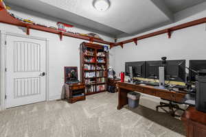 Office featuring a textured ceiling and carpet floors