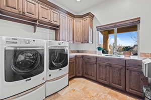 Laundry area with washer and dryer, stone tile flooring, cabinet space, and recessed lighting