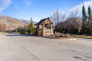 View of concrete road with curbs and a mountain view