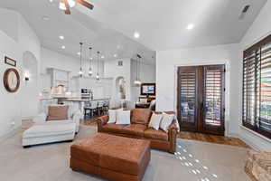Living area featuring arched walkways, a ceiling fan, vaulted ceiling, and recessed lighting
