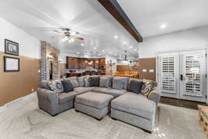 Carpeted living area featuring beam ceiling, recessed lighting, a ceiling fan, and wine cooler