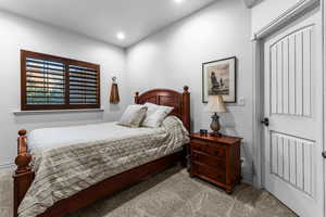 Carpeted bedroom with recessed lighting