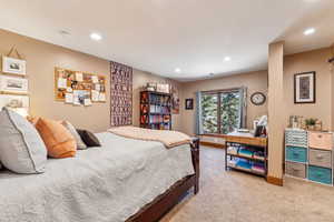 Bedroom with light colored carpet and recessed lighting