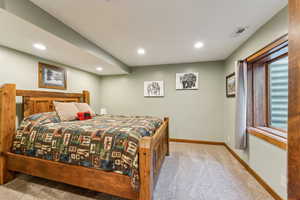 Carpeted bedroom with baseboards and recessed lighting