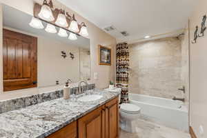 Full bathroom with vanity and shower / bath combo with shower curtain