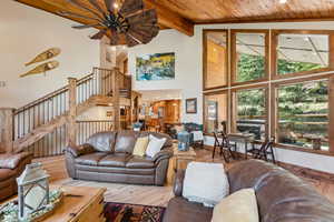 Living area with a high wooden beamed ceiling, hardwood / wood-style flooring, and recessed lighting