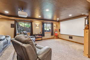 Home theater with carpet floors, recessed lighting, and a textured ceiling