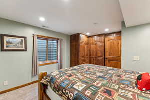 Bedroom with a closet, carpet floors, and recessed lighting