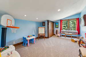 Playroom featuring recessed lighting, light colored carpet, and vaulted ceiling