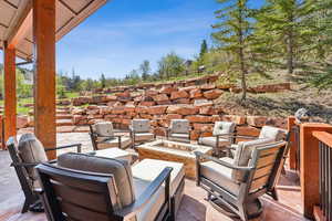View of patio with an outdoor living space with a fire pit