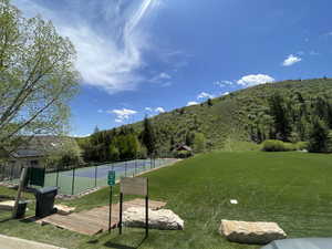 View of community featuring a tennis court