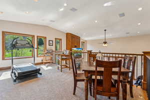 Dining space featuring lofted ceiling, light colored carpet, recessed lighting, and a ceiling fan
