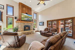 Living area featuring a fireplace, carpet, plenty of natural light, lofted ceiling, and recessed lighting