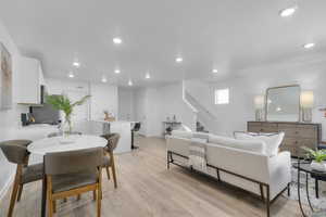 Living room with light wood-style floors and recessed lighting