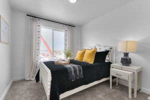 Bedroom featuring baseboards and light carpet