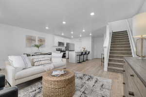 Living room featuring light wood finished floors and recessed lighting