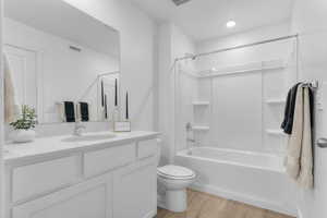 Bathroom featuring vanity, light wood-style flooring, and washtub / shower combination