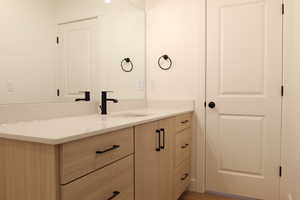 Bathroom with vanity and light wood-type flooring