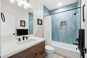Full bathroom featuring vanity and shower / bath combination with curtain