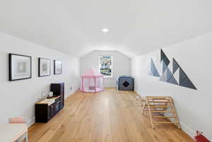 Additional living space featuring baseboards and light wood finished floors